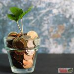 coins in a glass with a money trere