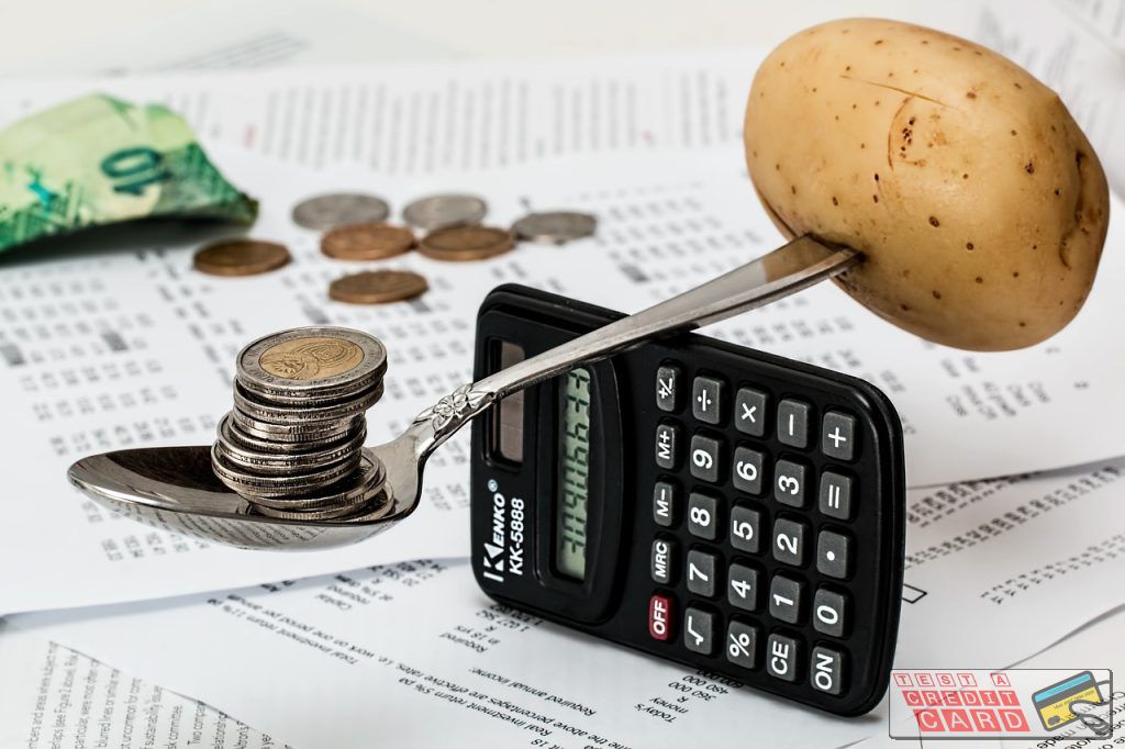 financial calculator with coins on desk